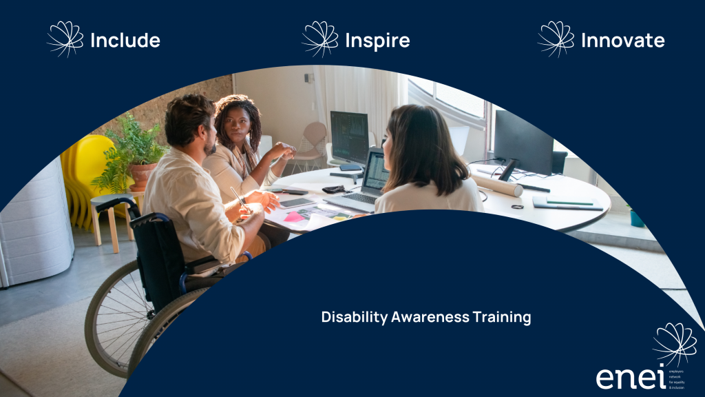 Include - Inspire - Innovate. Photo of a group of professionals working collaboratively at a desk. Male in the centre is sitting in a wheelchair.
