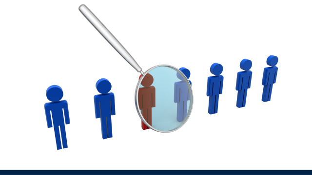 The image shows several figures in blue. magnifying glass hovers over one figure, which is a different colour from the rest.