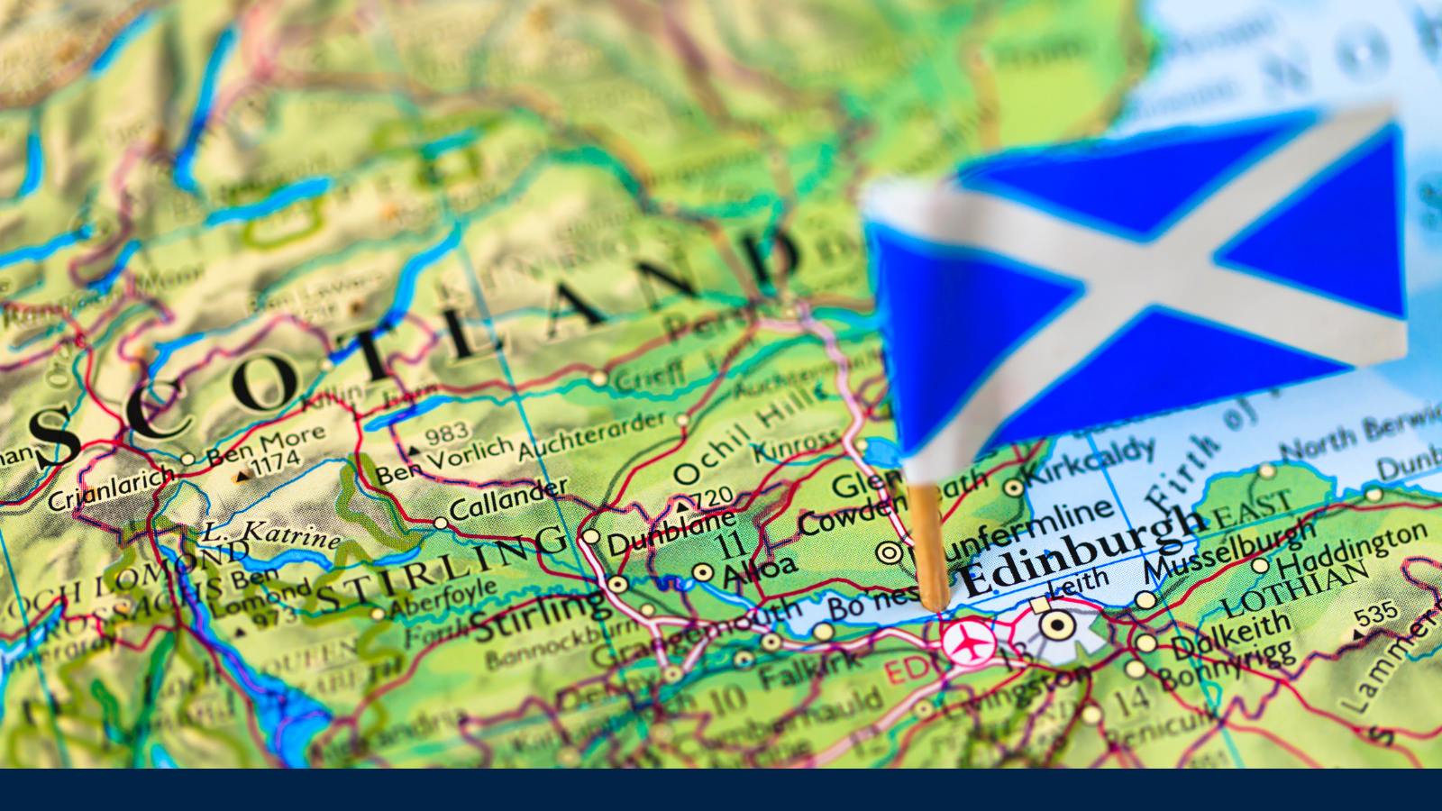 Image shows a Scottish flag pinned into a map of Scotland.