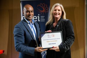 Award recipient being presented with their certificate.