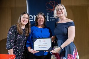Award recipient being presented with their certificate.