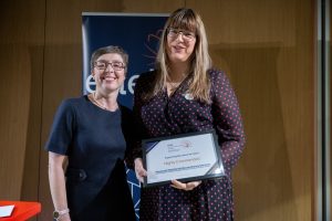 Award recipient being presented with their certificate.