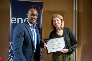 Award recipient being presented with their certificate.