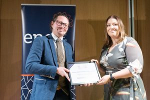 Award recipient being presented with their certificate.